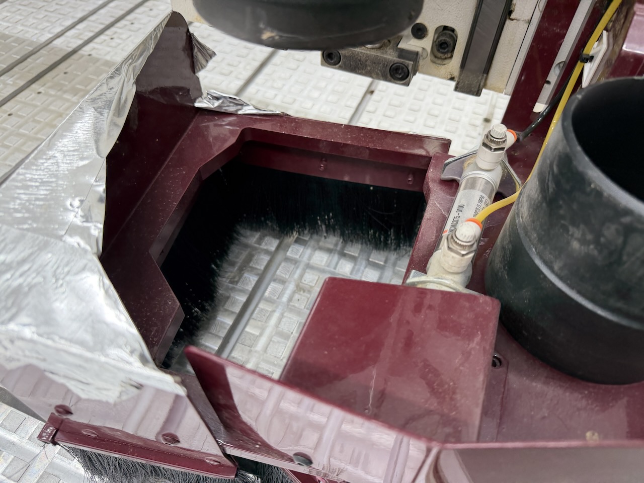 Dust collection shoe with brush skirt and vacuum duct